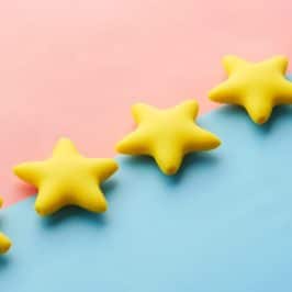 Five yellow stars on a blue and pink background
