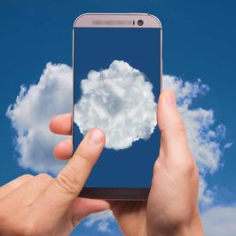Mobile phone being held up to the sky with image of cloud on screen
