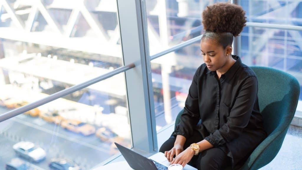 Female entrepreneur typing on laptop